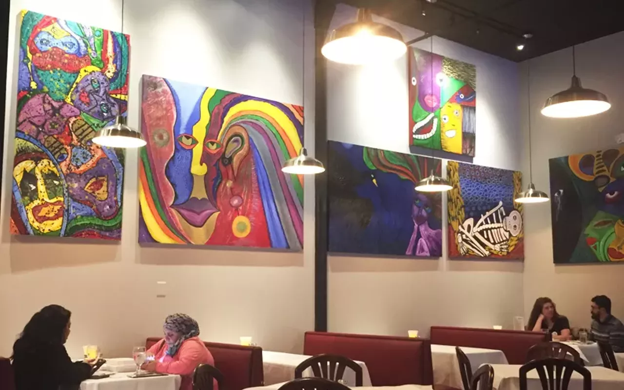 artist jose gomez created the paintings in cocina latina's dining room.